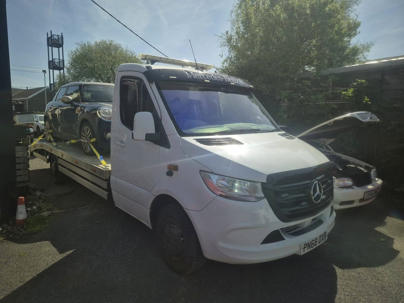 Weaves flatbed recovery truck loaded with a customer's car